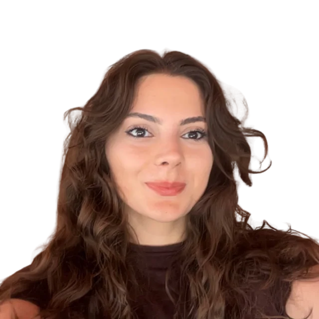 Smiling, with long wavy brown hair