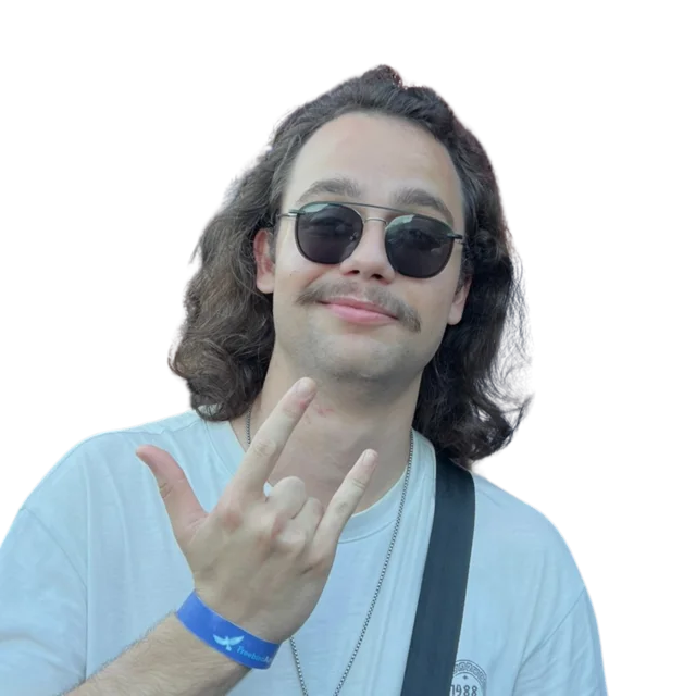 Wearing sunglasses and making a rock-on hand sign